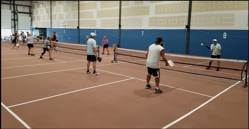 Diverse group engaged in an active pickleball lesson