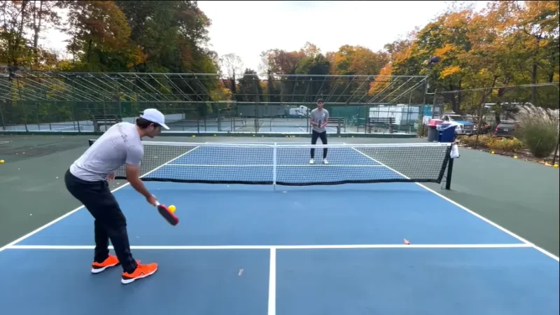 Two pickleball players engaged in a strategic dinking rally